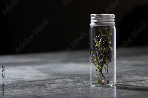 Flask with dried purple flowers