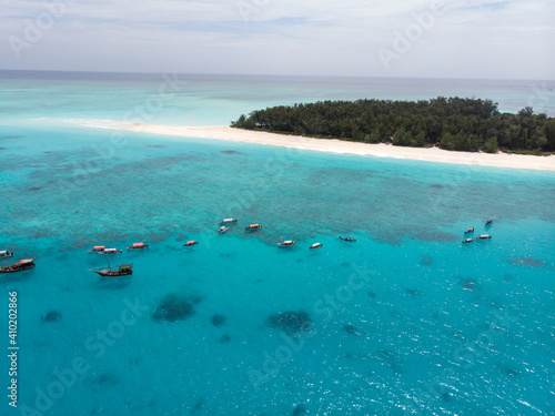 Aerial view of Boats Staying near Mnemba Atoll in Zanzibar - The Famous Spot for Snorkeling and Boat Tour © Oleksandr