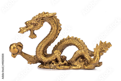 Bronze sculpture dragon holding pearl isolated on white background. Chinese symbol prosperity, wealth, good luck. Feng Shui. Side view