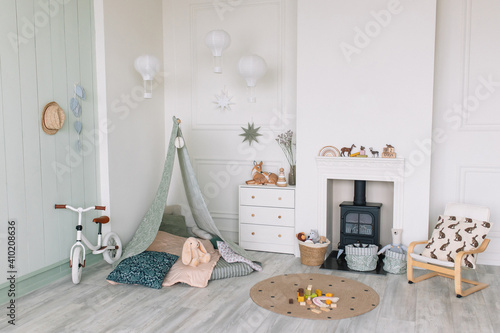 Hut and a bicycle for a child in a room with a fireplace