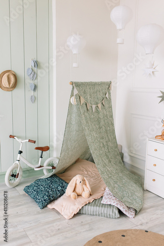 Children's corner with toys and a wigwam with pillow