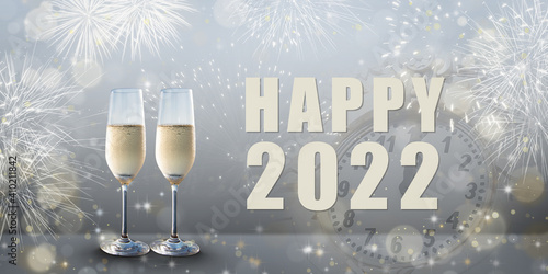 New Year celebration: Glasses of champagne and Happy 2022 text. Fireworks and clock in the background.