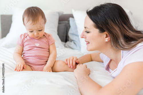 happy family. Mother and baby playing and smiling under a blanket