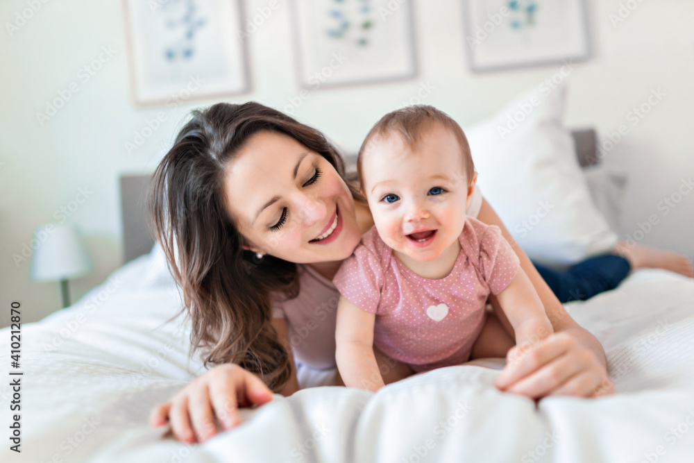 happy family. Mother and baby playing and smiling under a blanket happy family. Mother and baby playing and smiling under a blanket