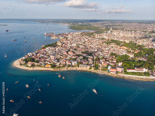 Zanzibar Aerial Shot of Stone Town Beach with Traditional Dhow Fisherman Boats in the Ocean at Sunset Time © Oleksandr