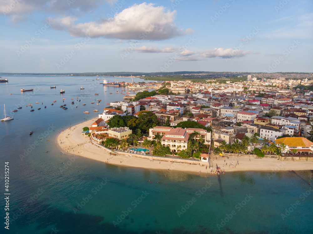 Zanzibar Aerial Shot of Stone Town Beach with Traditional Dhow Fisherman Boats in the Ocean at Sunset Time