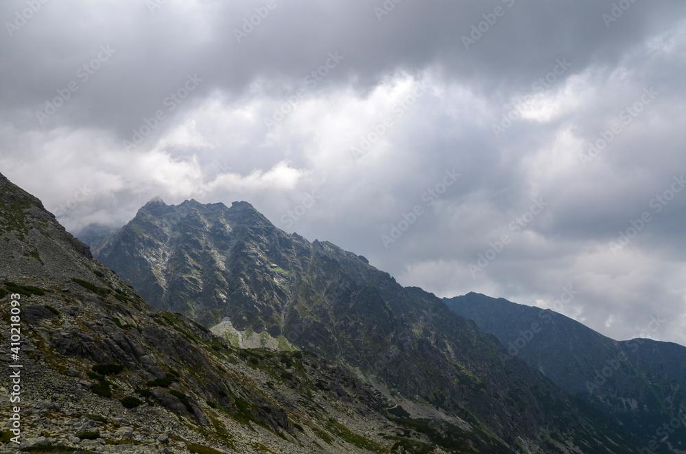 Amazing landscape with cloudy sky over majestic high rocky mountains in High Tatras, Slovakia