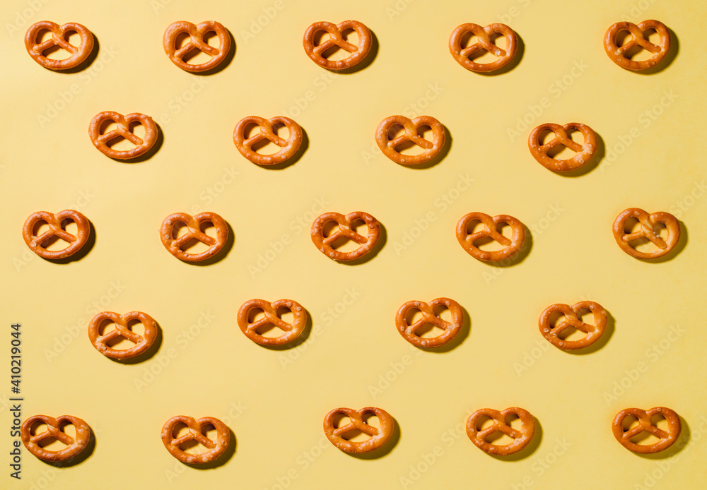 salt pretzels on yellow background salt pretzels on yellow background