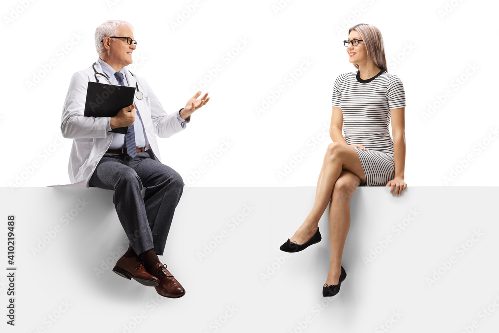Mature doctor sitting on a blank panel and talking to a young woman Mature doctor sitting on a blank panel and talking to a young woman