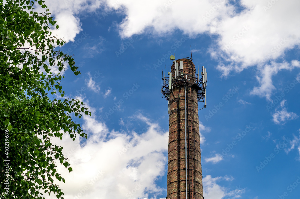 5G antennas on a brick pipe against a cloudy sky. Cellular antennas and Internet on the brick pipe of the boiler room 5G antennas on a brick pipe against a cloudy sky. Cellular antennas and Internet on the brick pipe of the boiler room
