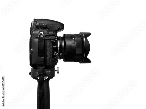 DSLR photo camera + wide angle lens standing on heavy tripod against the 255 white