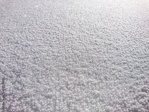 cool graphic structure of fluffy snow, snowy land, i.e. winter on a beautiful sunny and cold day. 