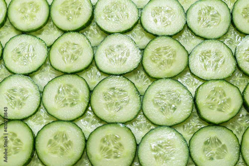 Fresh green slices of cucumber as background. Fresh green slices of cucumber as background.
