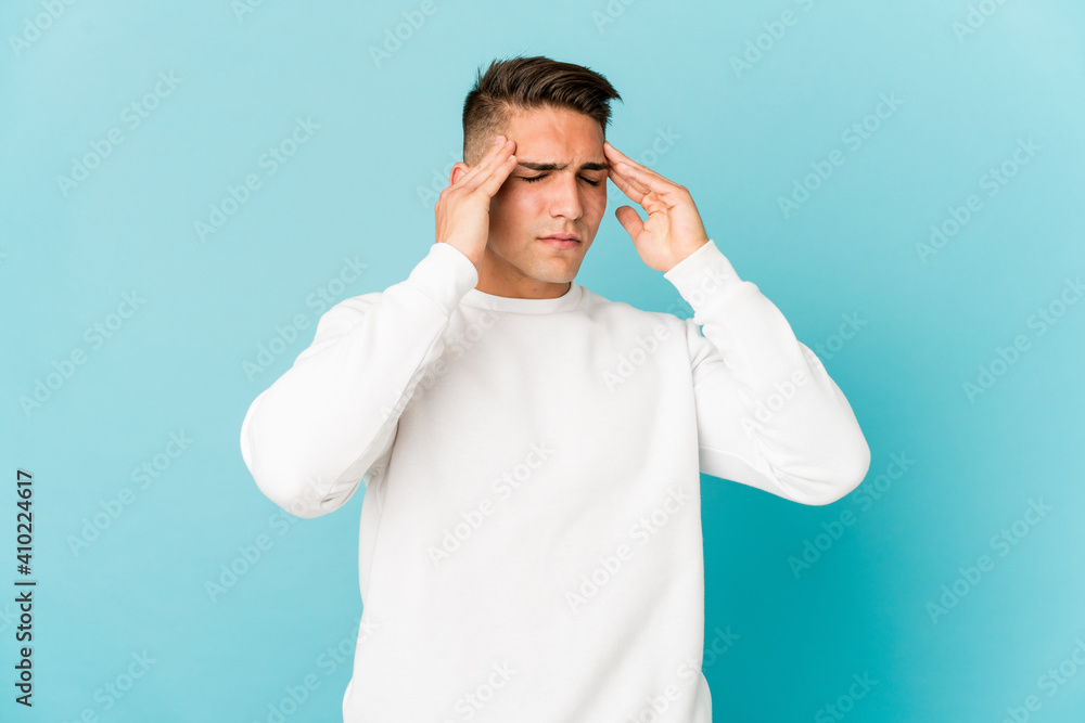 Young caucasian handsome man isolated touching temples and having headache. Young caucasian handsome man isolated touching temples and having headache.