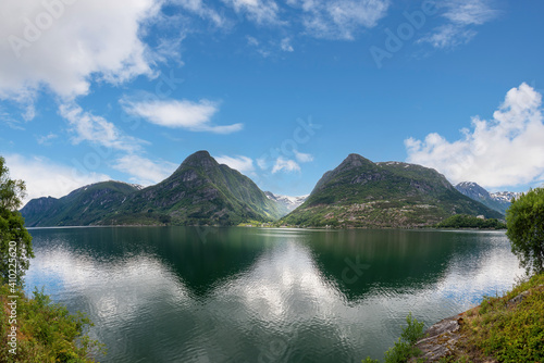 A reflection of mountains, water and forests in Norway.