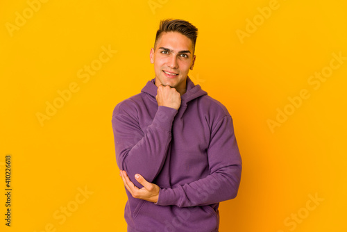 Young handsome caucasian man isolated smiling happy and confident, touching chin with hand.