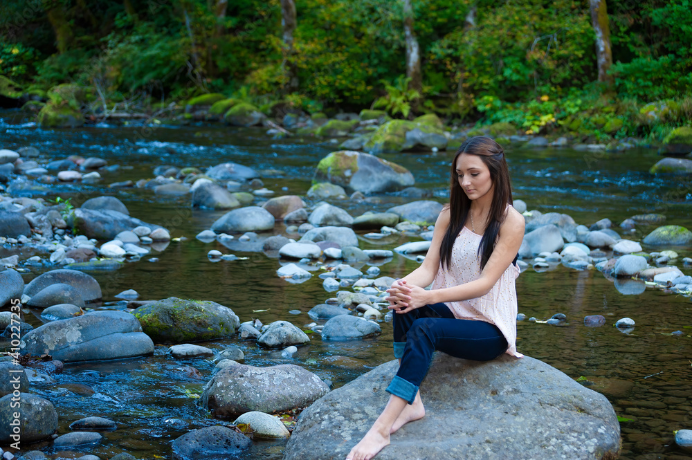 Young Woman Poses Along the Banks of a River Young Woman Poses Along the Banks of a River
