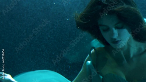 beautiful girl in colorful dresses under the water