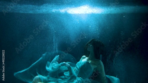 beautiful girl in colorful dresses under the water