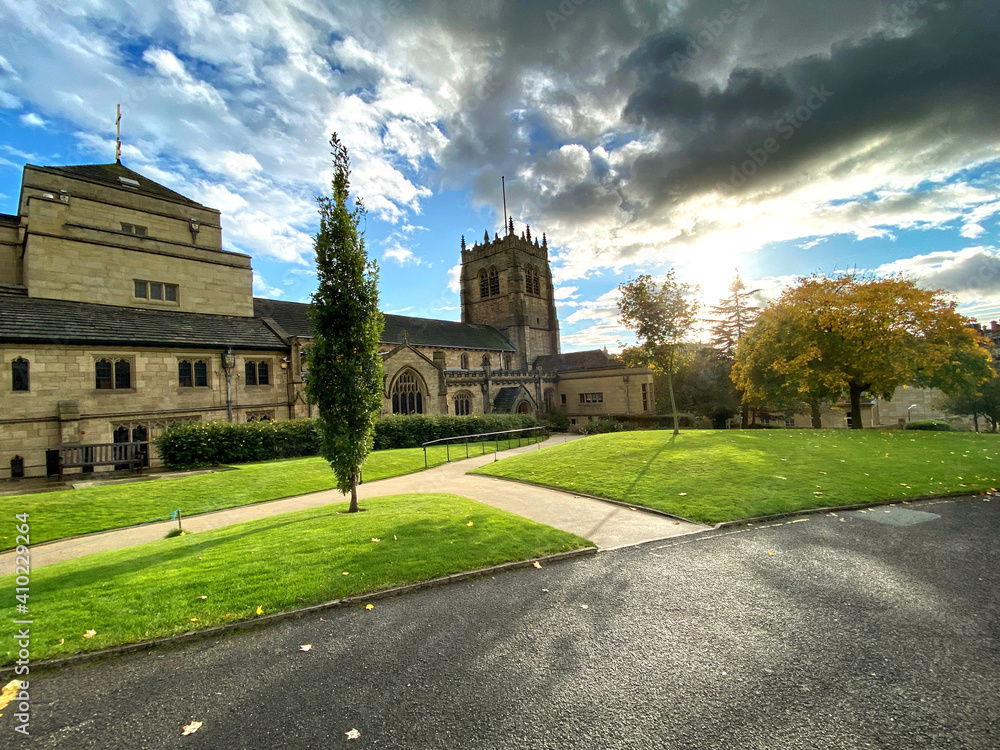 Obraz premium Sunset with rain clouds, over an old cathedral in, Bradford, Yorkshire, UK