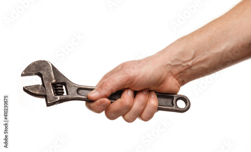 Cuadro en lienzo Adjustable wrench in the hands of a man on a white background isolate and close-