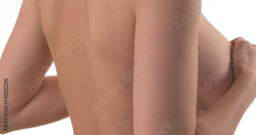 Close up of Caucasian woman's breasts covering with hands. Turning to camera in slow motion. Isolated on white background.
