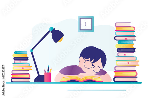Tired schoolboy sleeps at workplace. Young boy doing homework. Lot of textbooks on desktop. Student studying hard overnight.