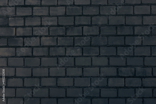 Dark grey brick wall. Abstract decorative grey background or art texture.
