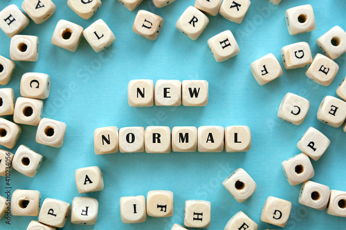 New normal word wooden alphabet cube. Blue background