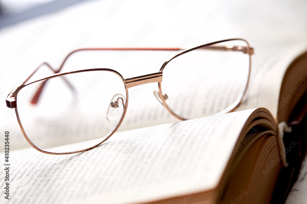 glasses on the book pages glasses on the book pages