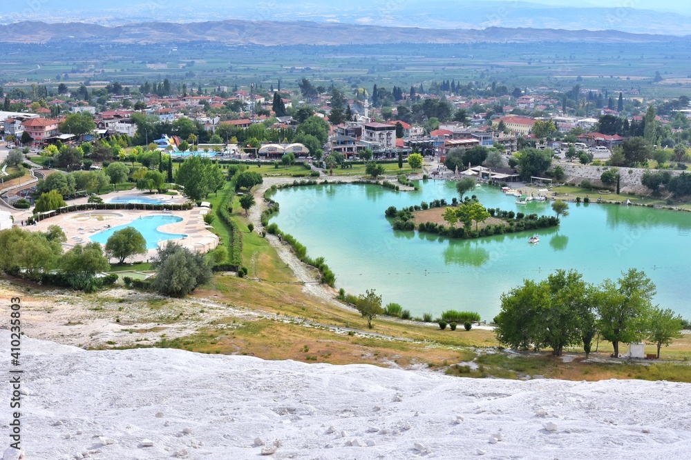 The surroundings of the famous Pamukkale travertines with beautiful tropical plants and swimming pool. Cotton castle in Turkey, Denizli Province.