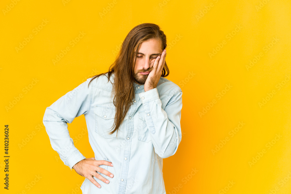 Young man with long hair look who is bored, fatigued and need a relax day. Young man with long hair look who is bored, fatigued and need a relax day.