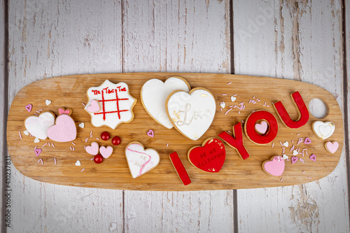 Romantic-themed cookies displayed on a wooden baord photo