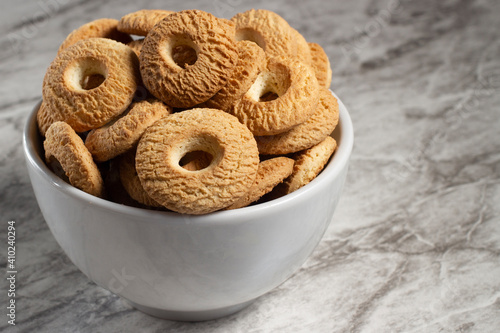 Ring Coconut biscuits served in a bowl. Brazilian little donut. Selective focus.