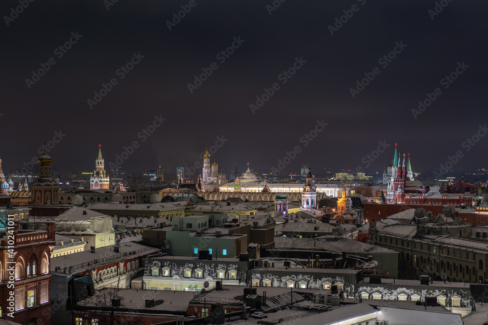 The roofs and towers of the city at night.