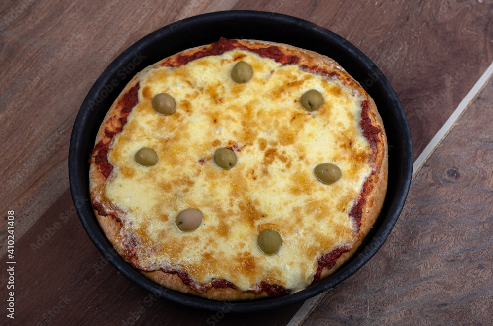 Home made cheese italian Pizza with tomate sauce and black background Home made cheese italian Pizza with tomate sauce and black background