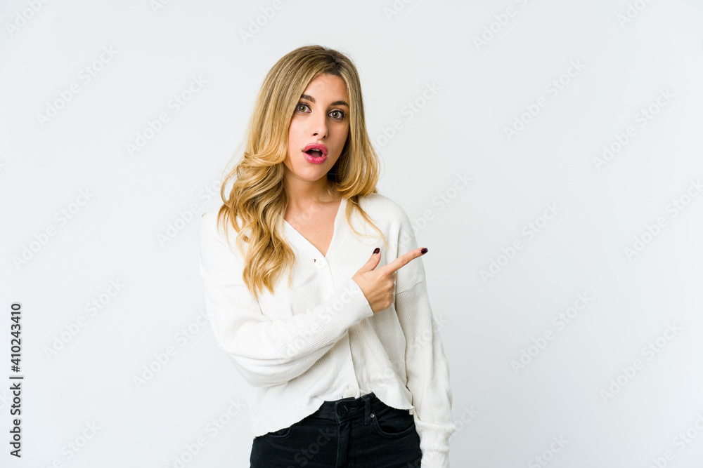 Young caucasian blonde woman pointing to the side Young caucasian blonde woman pointing to the side