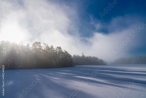 Winter Frost Scene on Ice Lake with low clouds or Fog