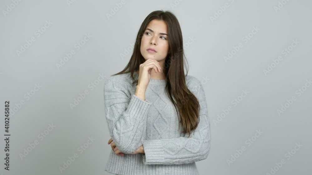 Teenager Brazilian girl having doubts while scratching head over isolated background Teenager Brazilian girl having doubts while scratching head over isolated background