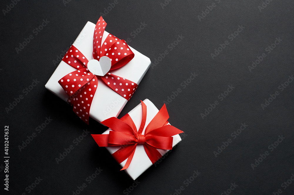 Valentines day gift boxes decorated with heart on black background Valentines day gift boxes decorated with heart on black background