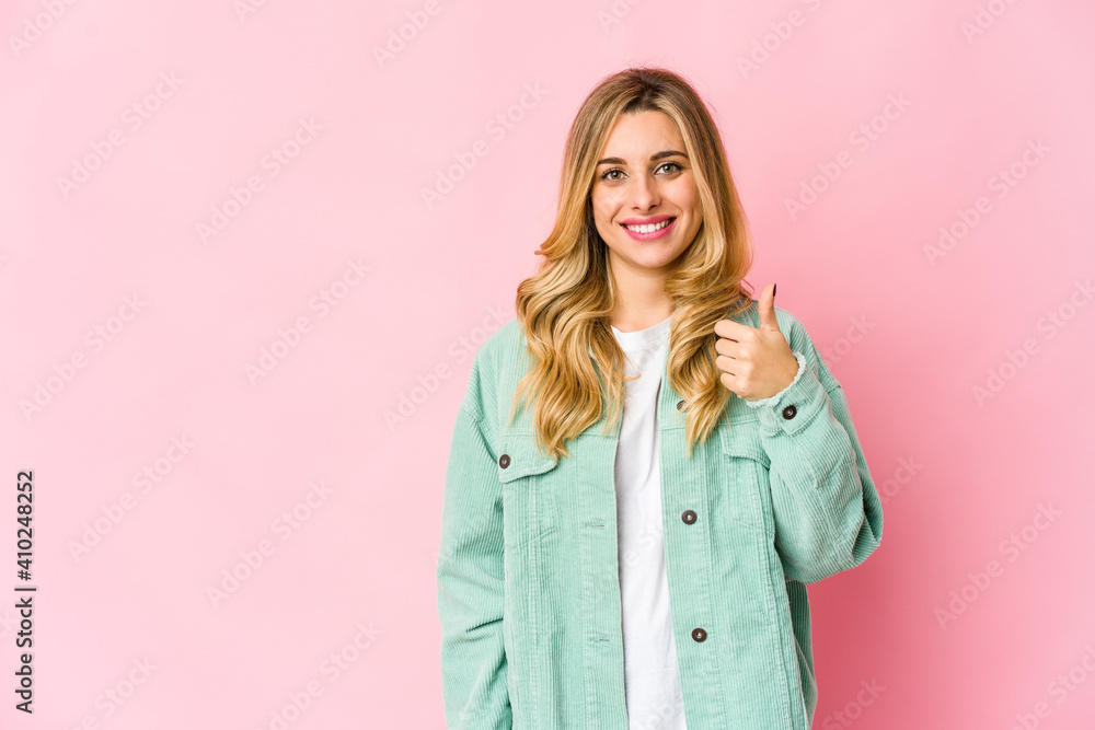 Young caucasian blonde woman smiling and raising thumb up Young caucasian blonde woman smiling and raising thumb up