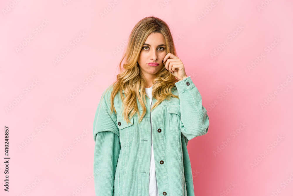Young caucasian blonde woman with fingers on lips keeping a secret. Young caucasian blonde woman with fingers on lips keeping a secret.