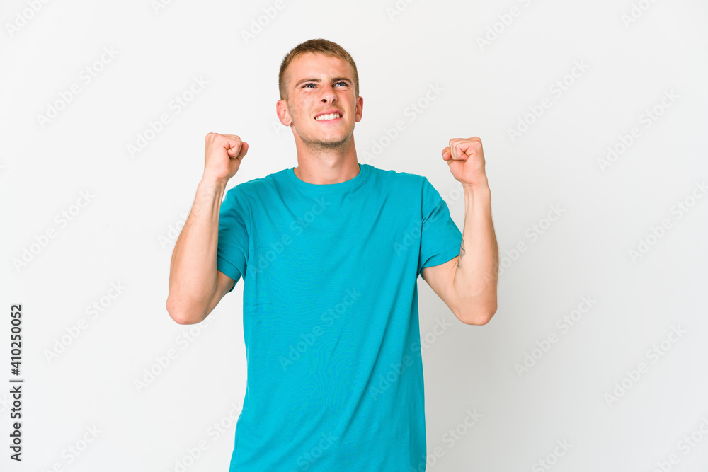 Young caucasian handsome man raising fist after a victory, winner concept. Young caucasian handsome man raising fist after a victory, winner concept.