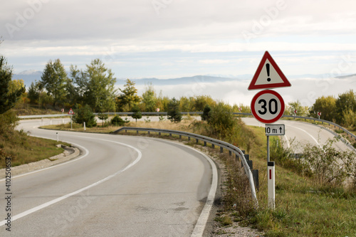 a traffic warning sign before a sharp bend in the road
