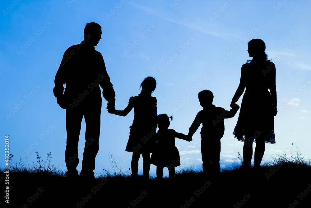 happy family by the sea on nature silhouette background