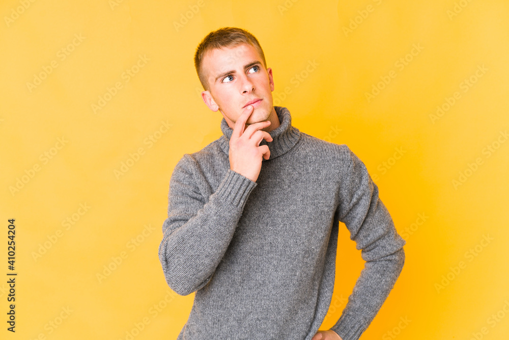 Fototapeta premium Young caucasian handsome man looking sideways with doubtful and skeptical expression.