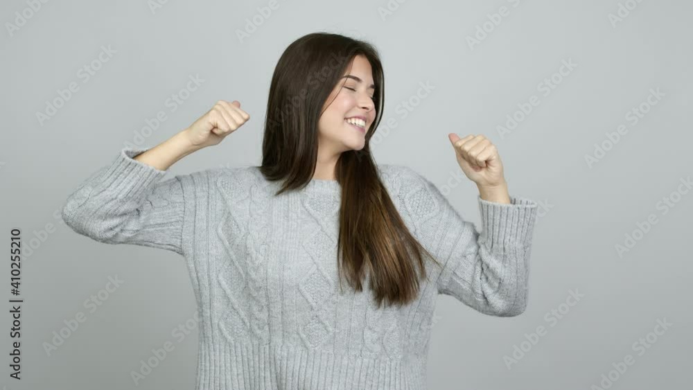 Teenager Brazilian girl giving thumbs up and smiling because something good has happened over isolated background Teenager Brazilian girl giving thumbs up and smiling because something good has happened over isolated background