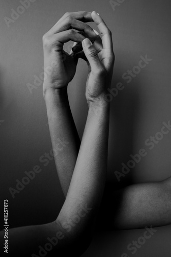 Black and white hands interlacing each other © sashapritchard