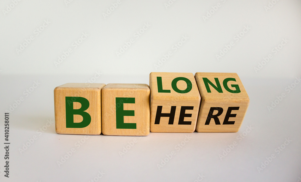 Be here belong symbol. Turned cubes and changed words 'be here' to 'belong'. Beautiful white background. Business, belonging and be here belong concept. Copy space. Be here belong symbol. Turned cubes and changed words 'be here' to 'belong'. Beautiful white background. Business, belonging and be here belong concept. Copy space.