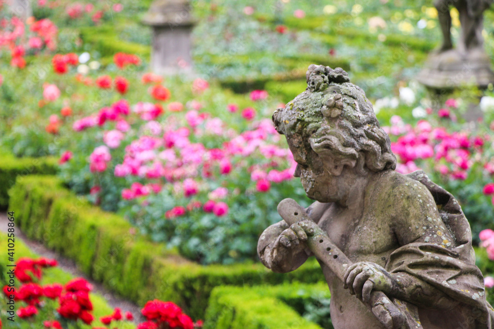 Statue in a rose garden of Paris